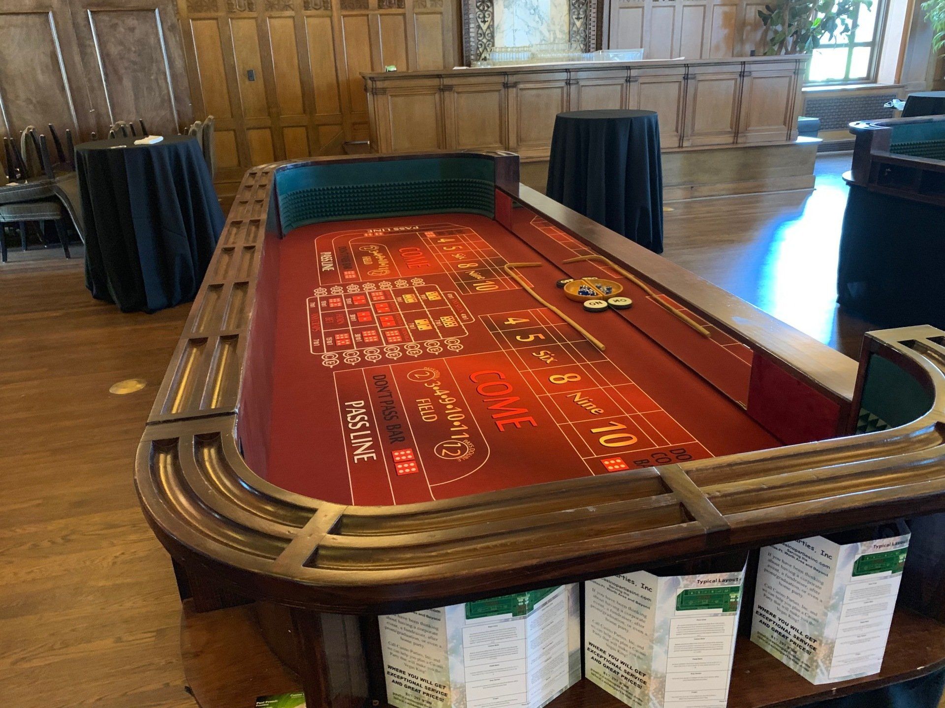 A large roulette table is sitting on top of a wooden table in a room.
