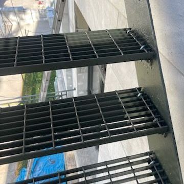 A close up of a metal staircase on the side of a building.