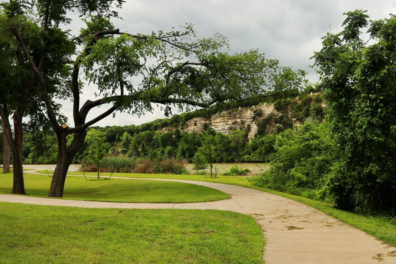 Path Through a Green Park With Trees and a Hillside Under a Cloudy Sky — Chop n Drop Tree Specialists in Cameron Park, NSW