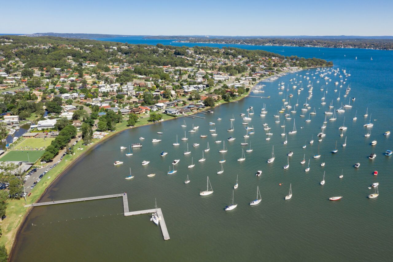 Coastal View With Numerous Sailboats Anchored in the Blue Water — Chop n Drop Tree Specialists in Eleebana, NSW