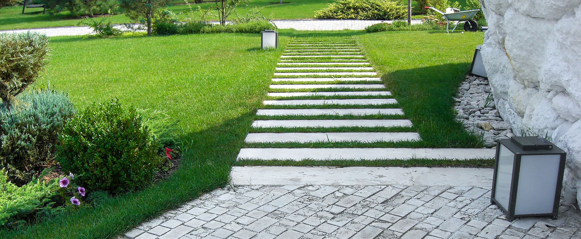 custom concrete paver pathway leading to a driveway