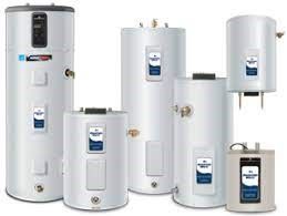 A collection of white electric water heaters of various sizes.