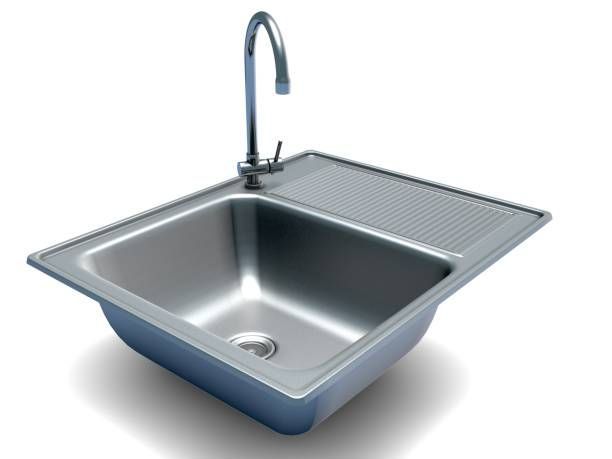 Stainless steel kitchen sink with attached drainboard and faucet.