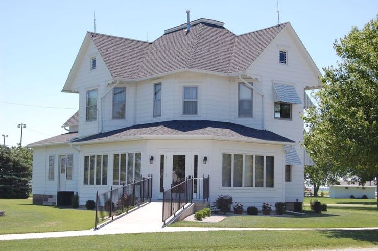 A large white house with a curved roof