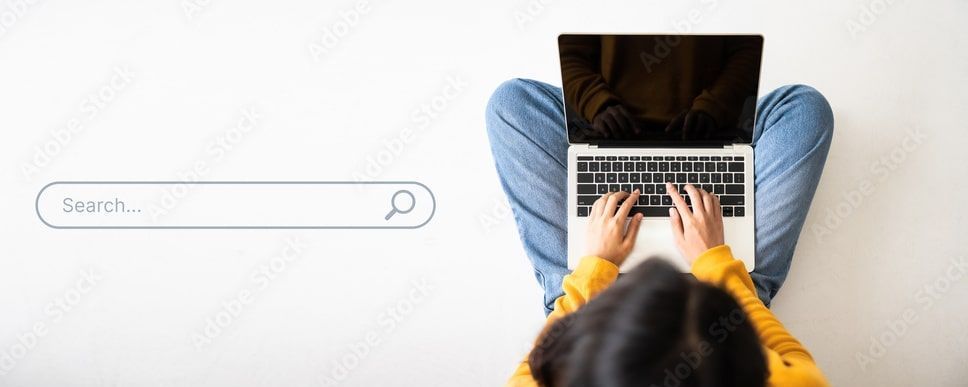 women sitting at laptop and typing 