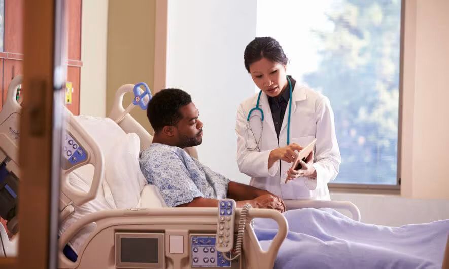 Doctor discussing medication with a senior couple in an office setting.