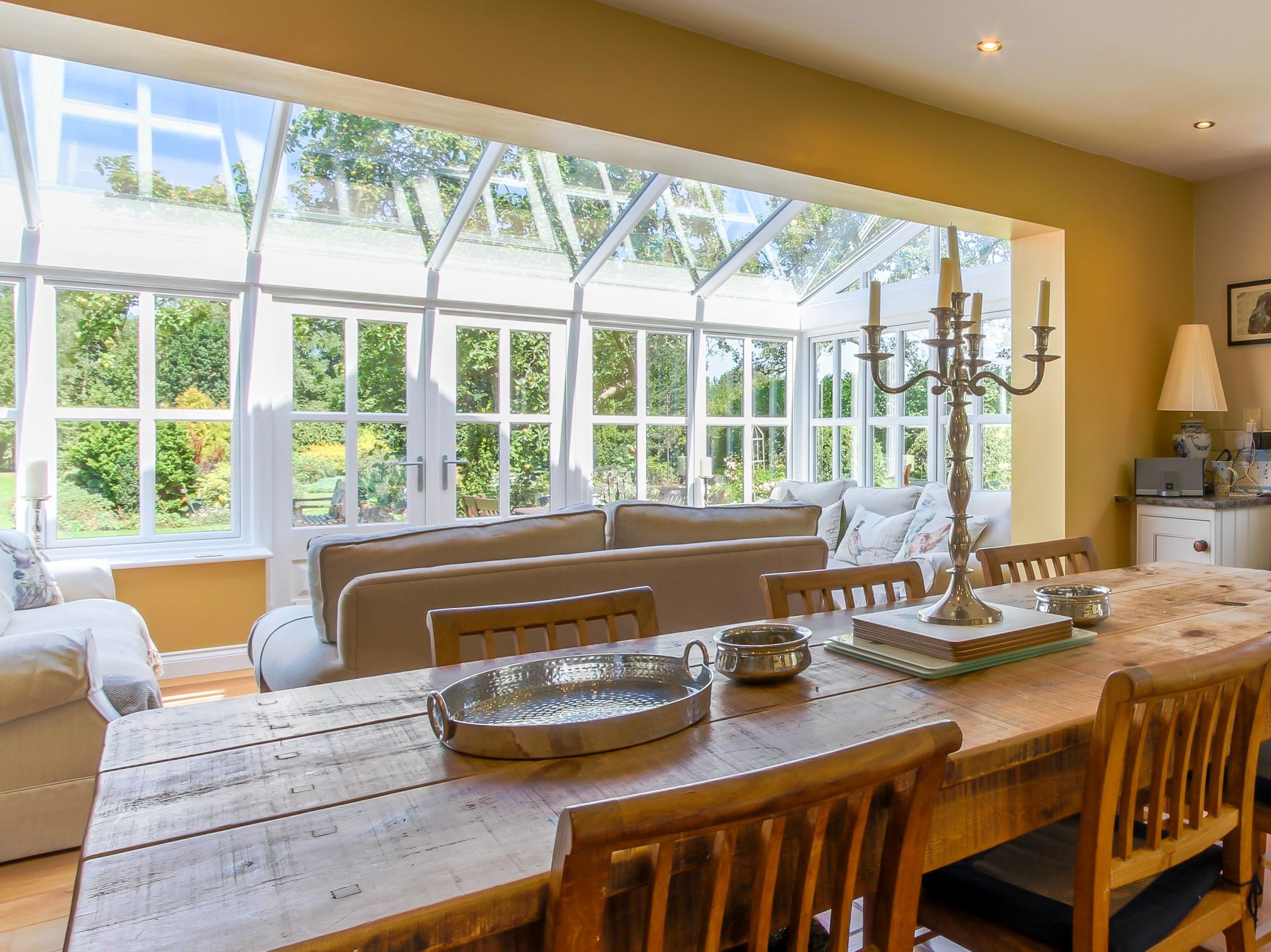 Interior View of Home Orangery as Living Space with Wooden Dining Room Table
