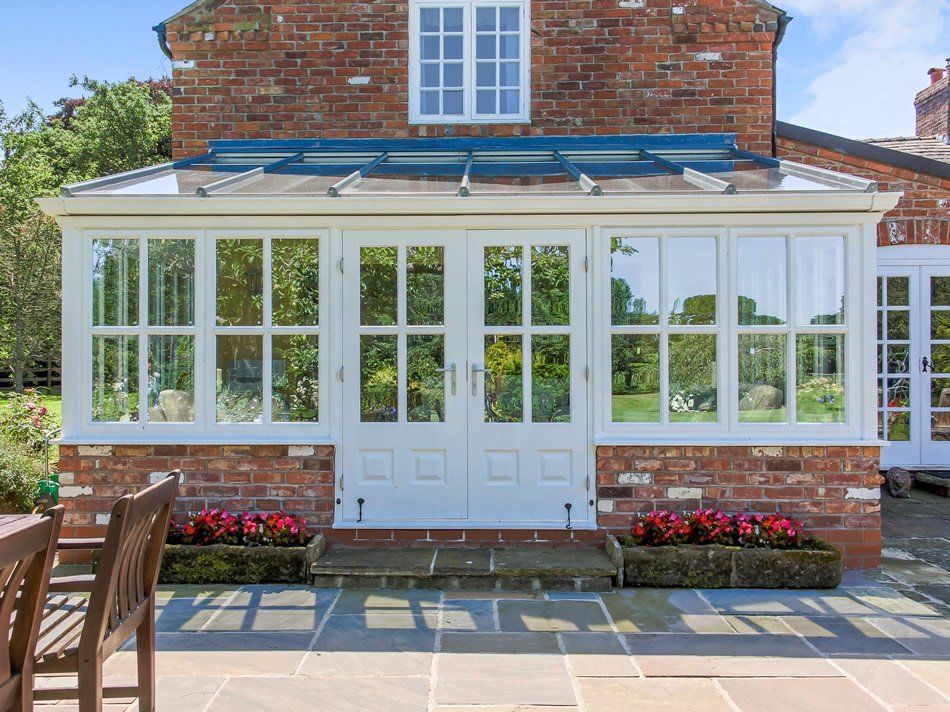 Front Door Entrance to White Conservatory with Brick Trim installed by Holts Orangeries