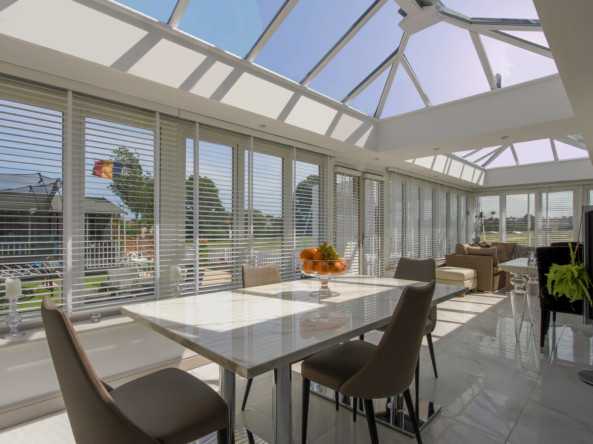 Interior View of Home Orangery Living Space with Kitchen Table Set and Couch