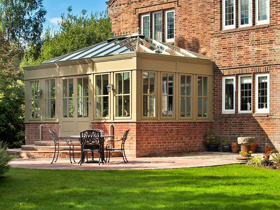 Yellow Coloured Orangery Home Addition with Brick Trim Installed by Holt Orangeries