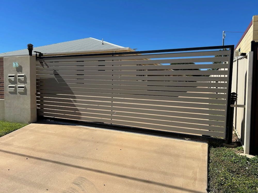 A Sliding Gate Is Sitting In Front Of A House — PH Davie in Bedourie, QLD