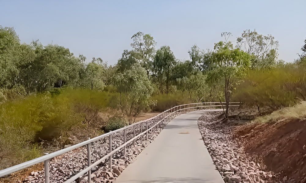 A Concrete Path With A Metal Railing Going Through A Forest — PH Davie in Mount Isa, QLD