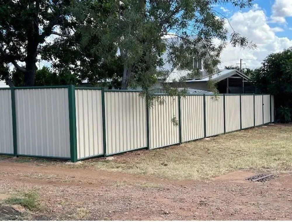 A White And Green Fence Surrounds A Dirt Field — PH Davie in Bedourie, QLD
