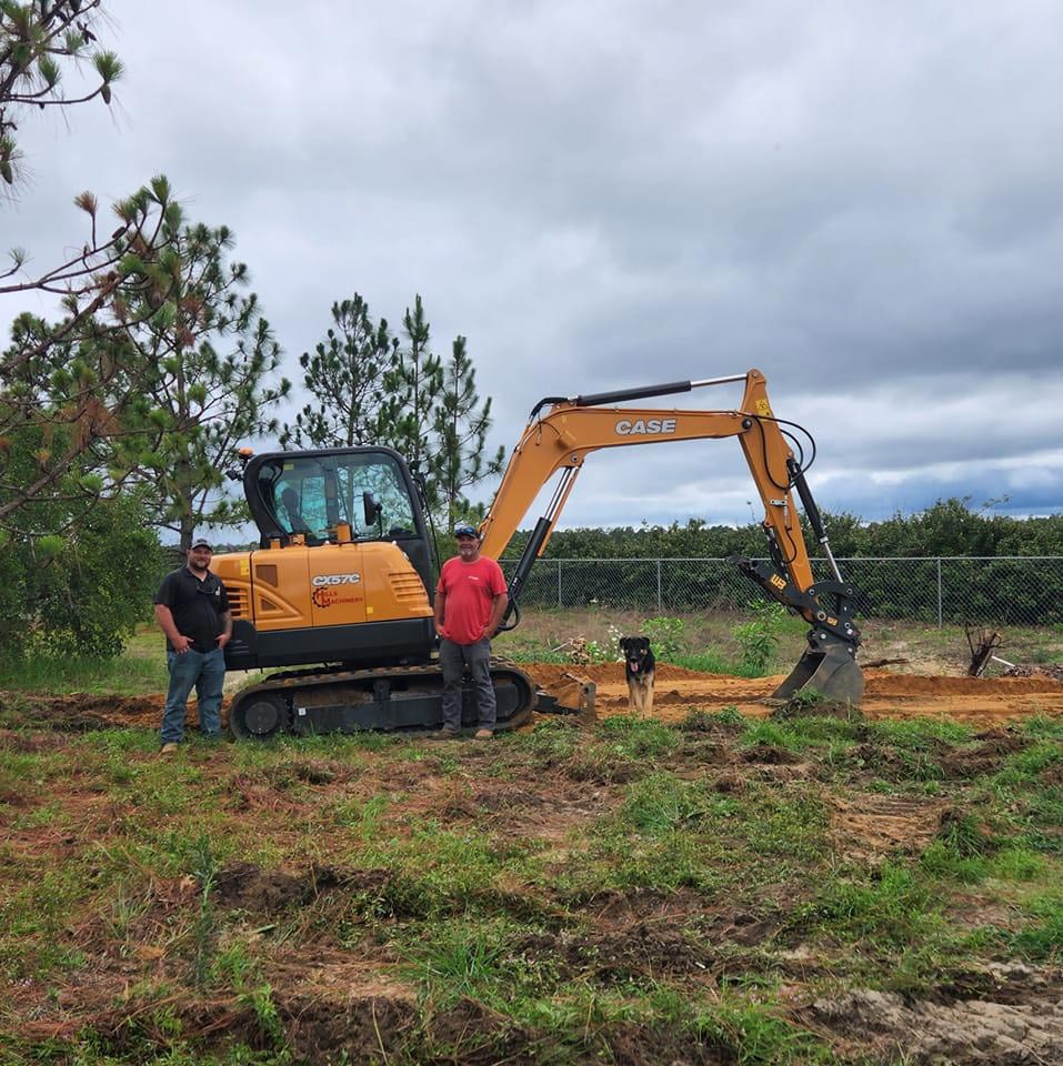 Two Men Beside Excavator — Pelion, SC — Hereford and Son LLC