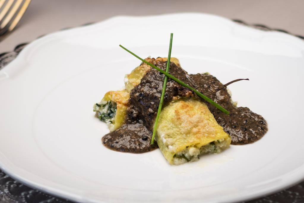 Un piatto bianco condito con cibo e una forchetta su un tavolo.