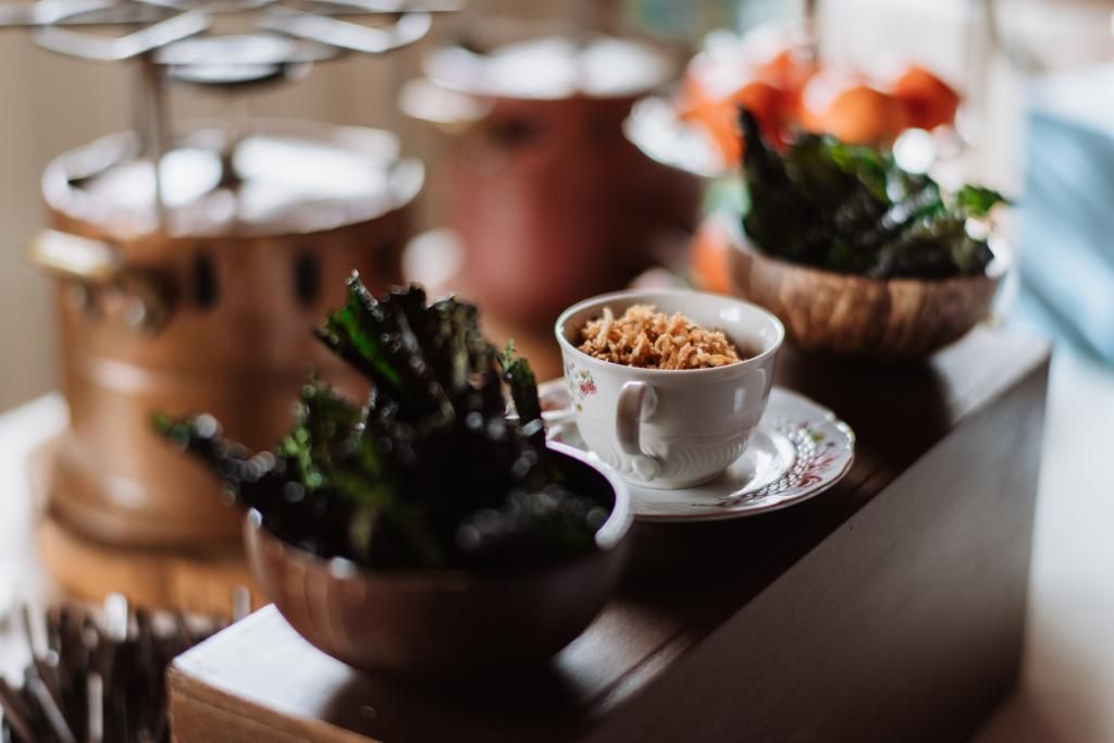 Un tavolo sormontato da ciotole di cibo e tazze di caffè.