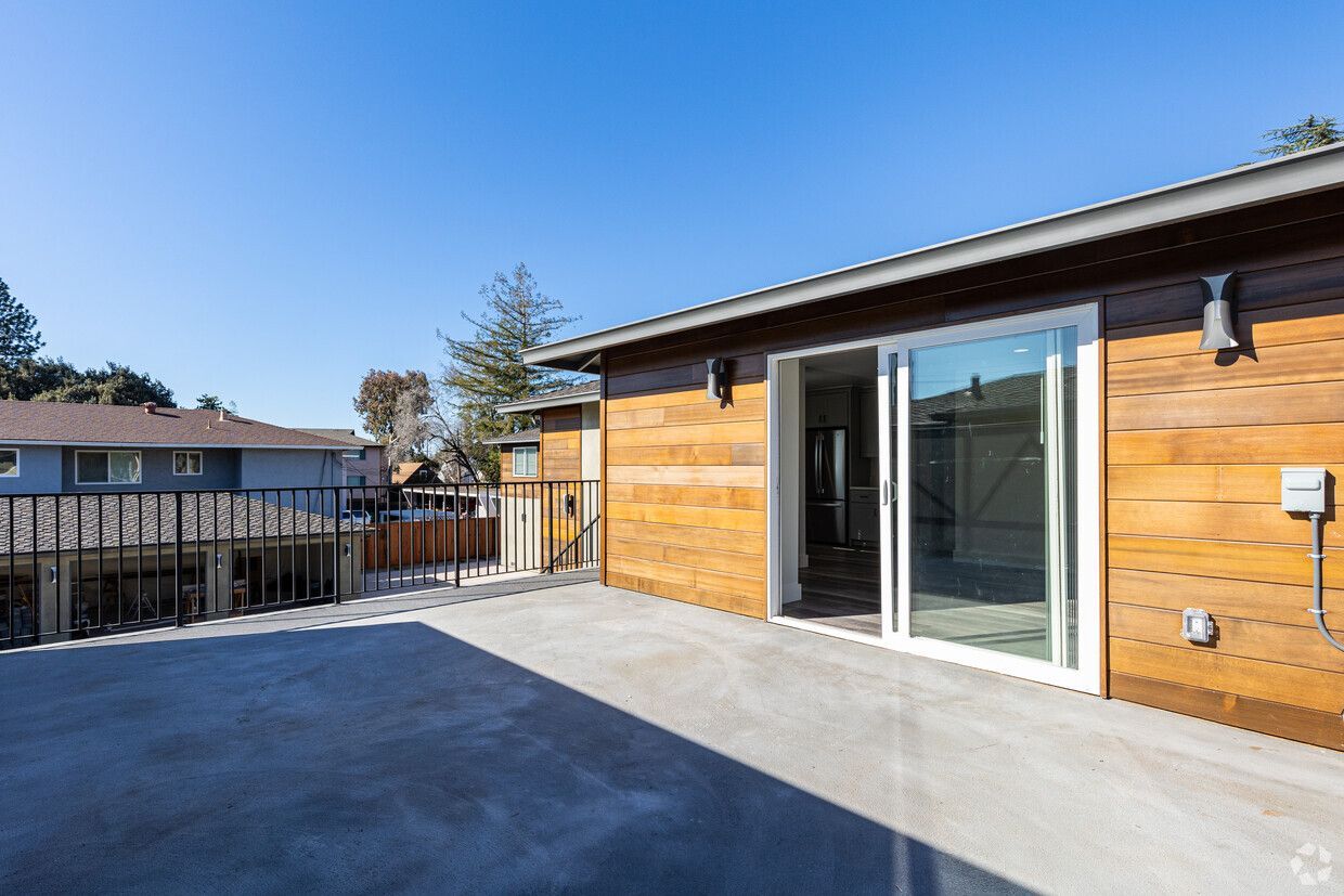 A house with a patio and sliding glass doors.