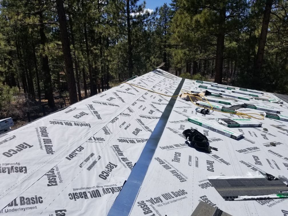 A roof is being built with a roofing material that says basic on it.