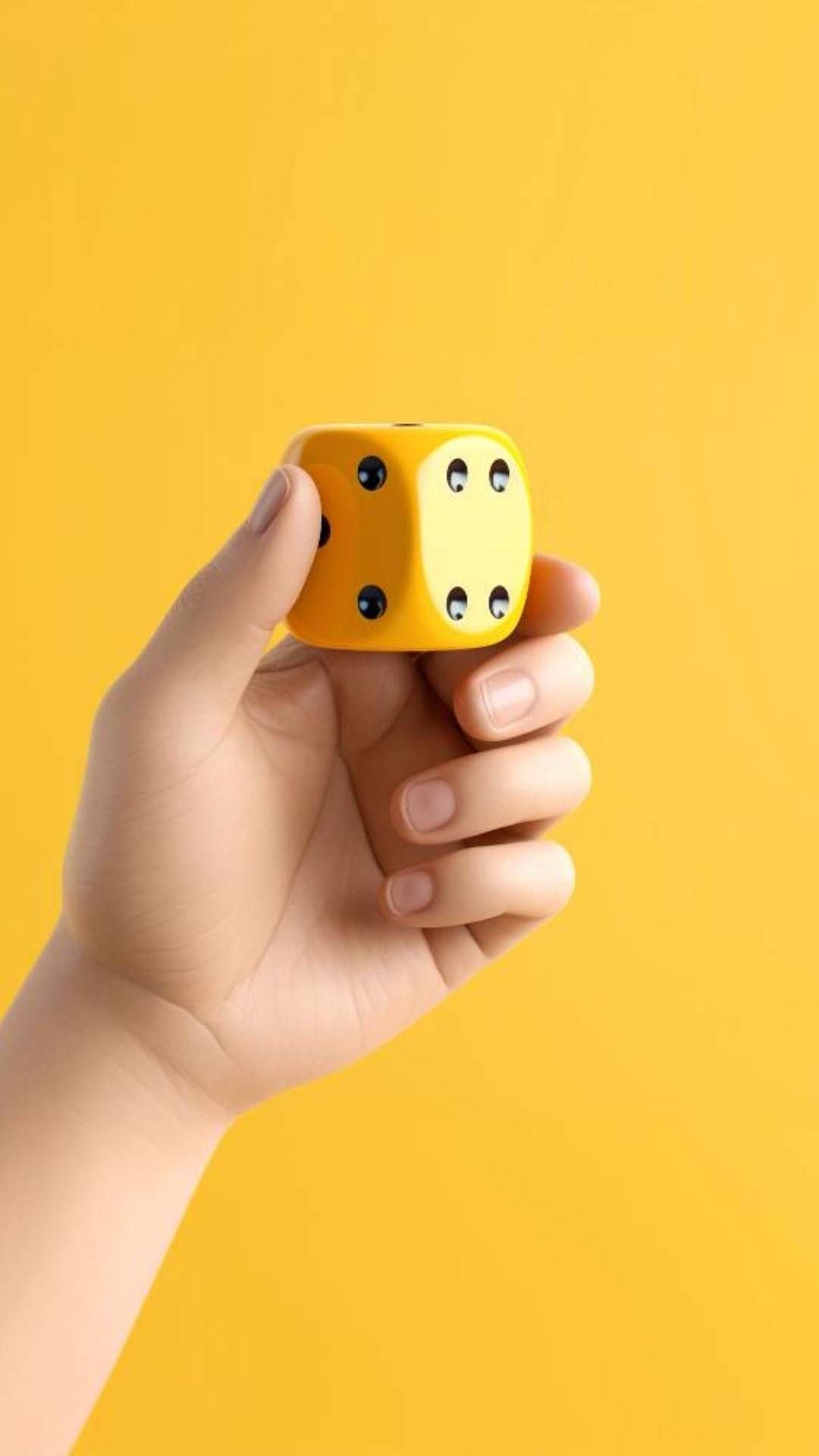 Six-sided yellow dice with numbers 1 through 6, showing the possibilities of chance.