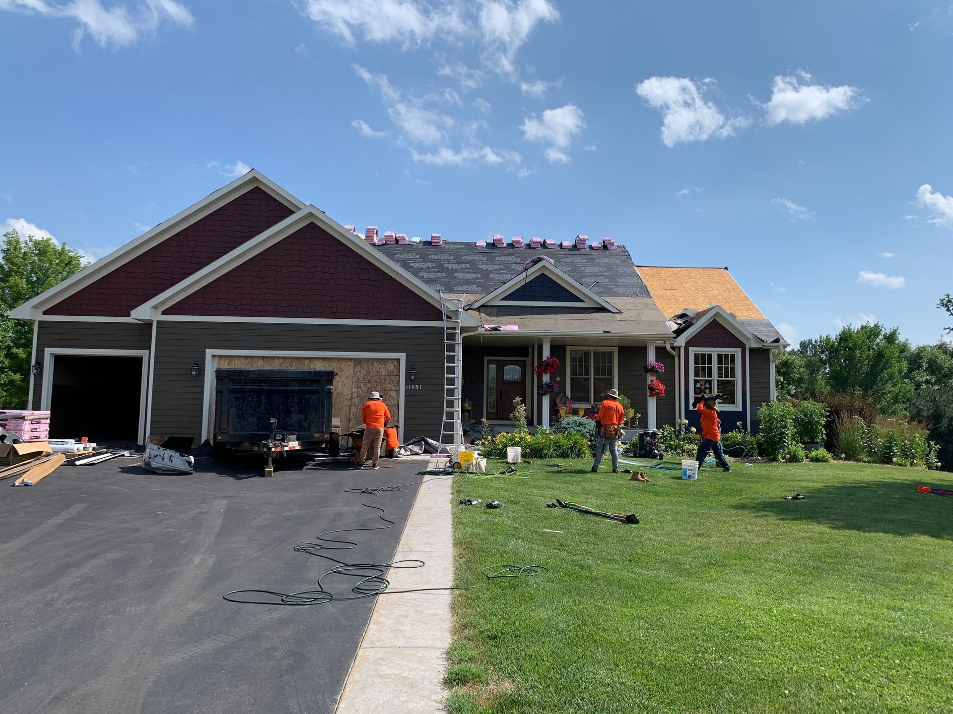 Denver roofing contractor inspecting a residential roof for repair or replacement after storm damage