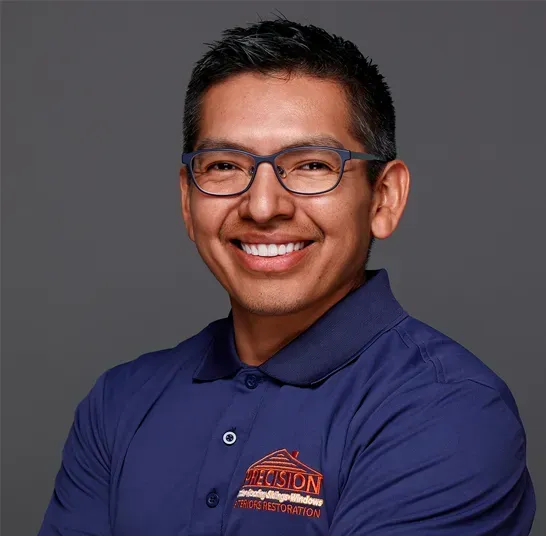 A man wearing glasses and a blue shirt with the word benson on it