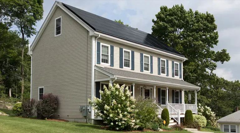 A large house with solar panels on the roof