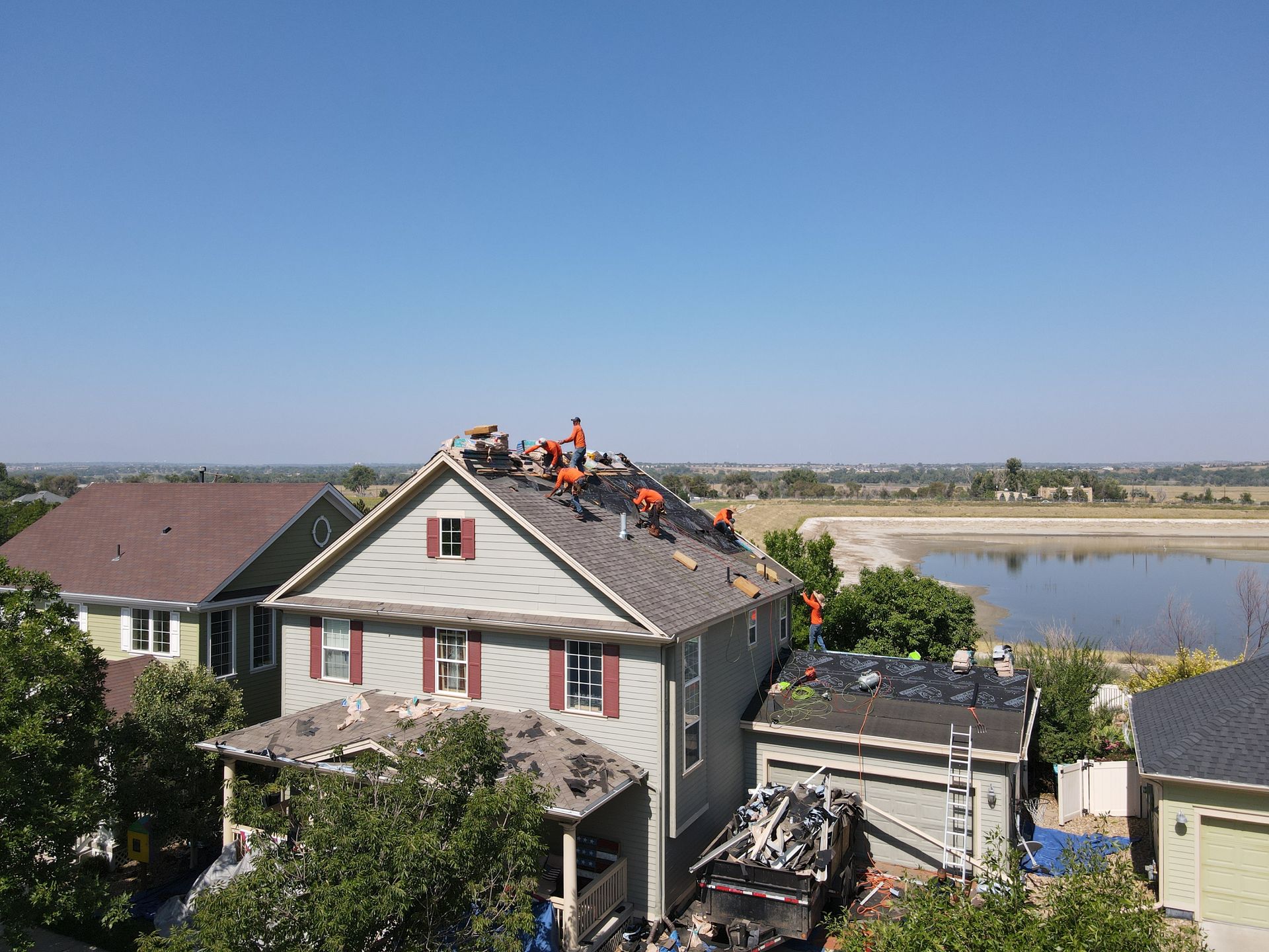 Precision Exteriors crew replacing a storm-damaged roof on the Front Range