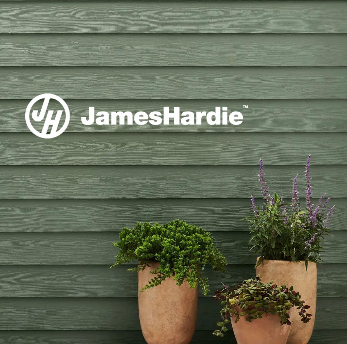 Two potted plants in front of a james hardie sign