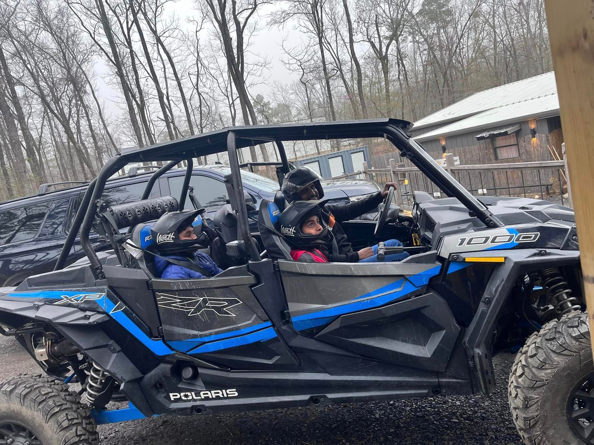 A group of people are riding in a polaris atv.