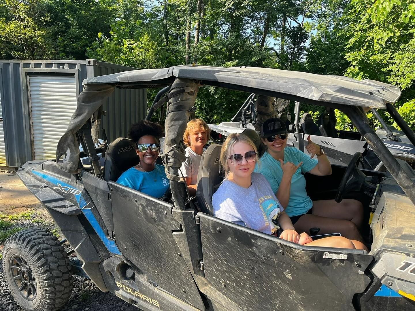 A group of people are sitting in a atv.