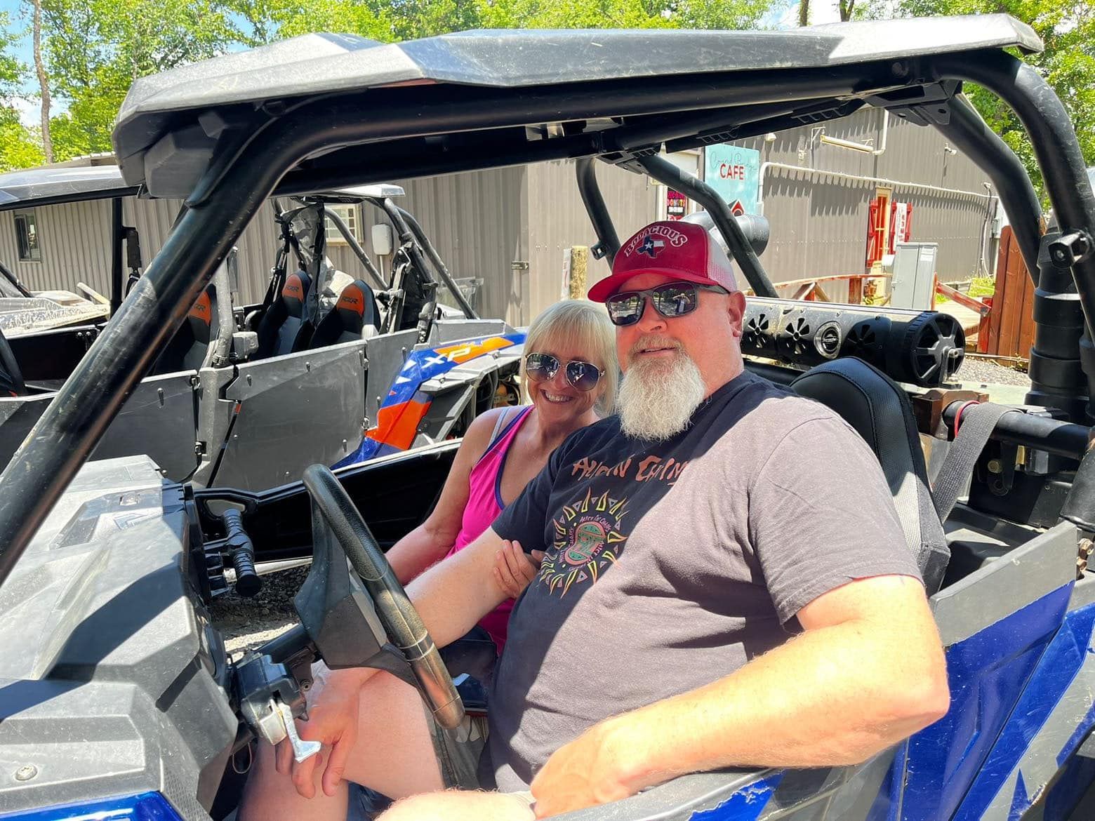 A man and a woman are sitting in a atv.
