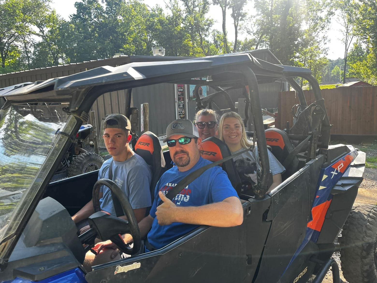 A group of people are sitting in a atv.