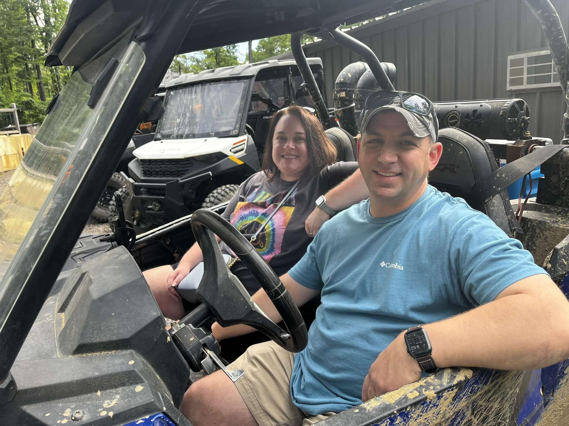 A man and a woman are sitting in a atv.