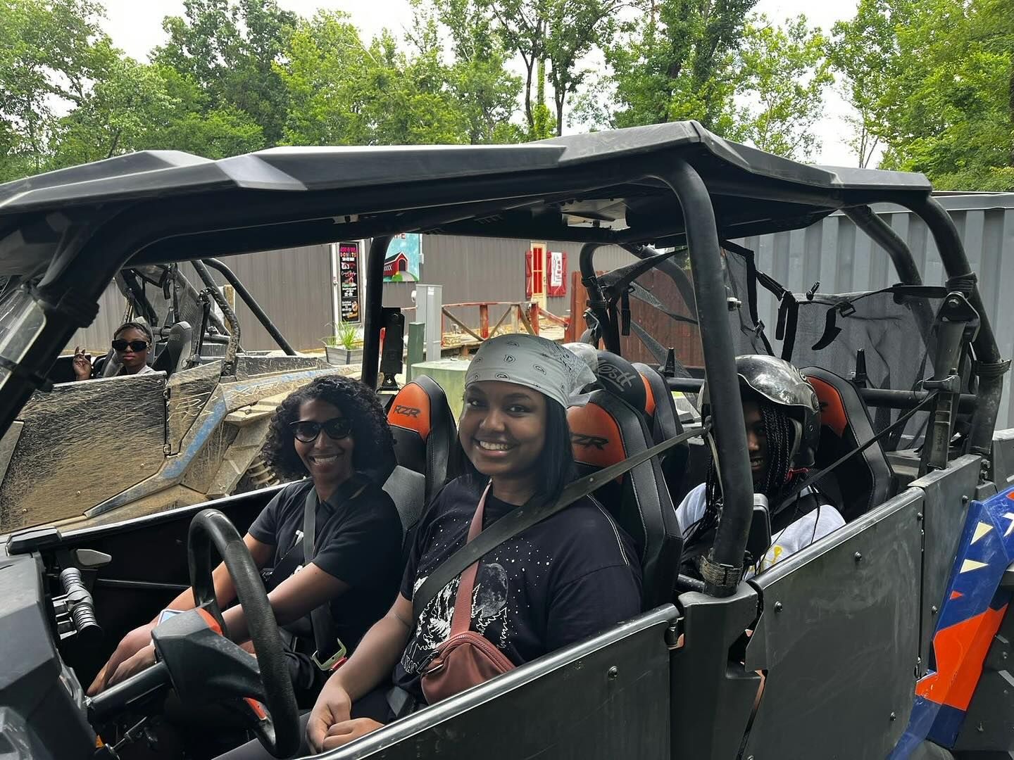 A group of people are sitting in a atv.