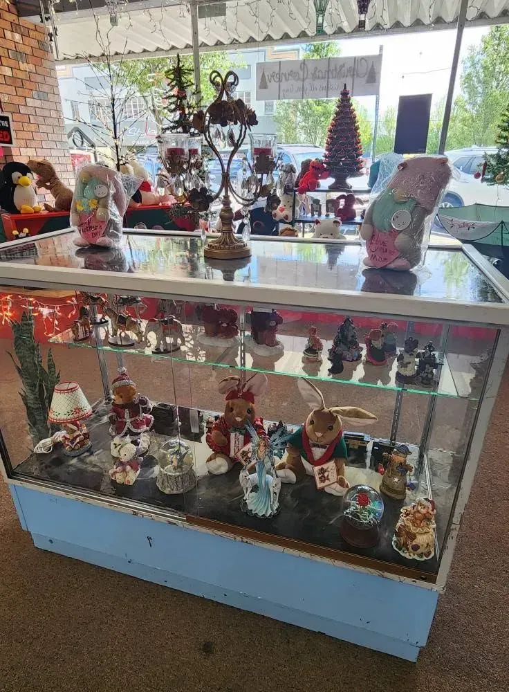 Display case with various figurines, ornaments, and decor items in a store.