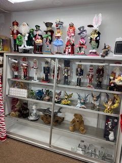 Display case filled with decorative nutcrackers and figurines in a shop setting.