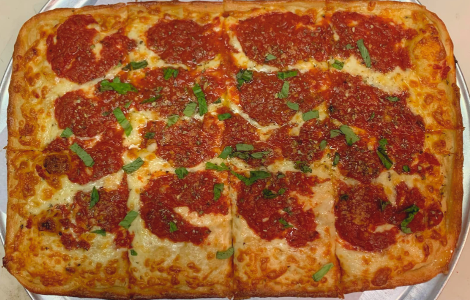 Pizza with green olives, smoked bacon and fresh basil