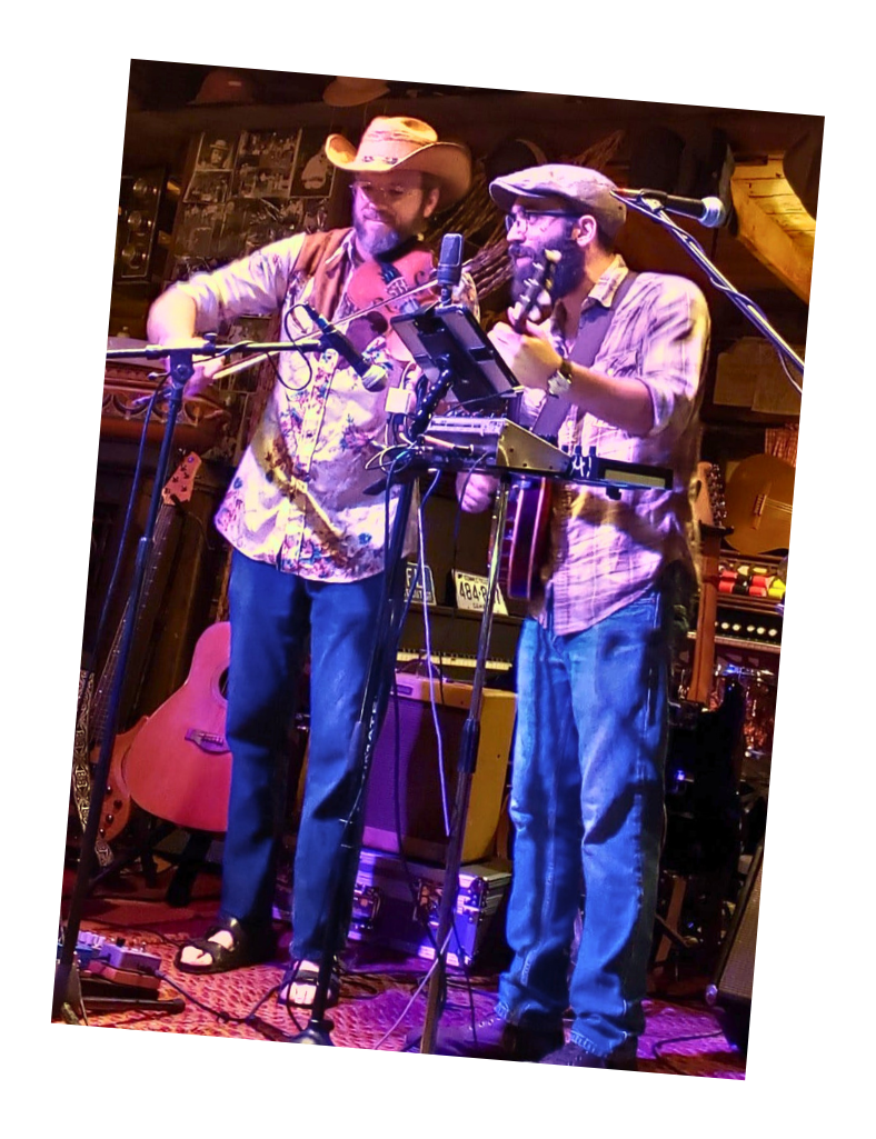 Amber Anchor playing stringed instruments on stage.