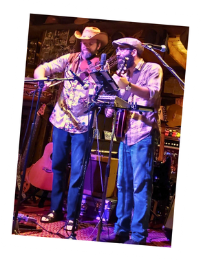 Amber Anchor playing stringed instruments on stage.