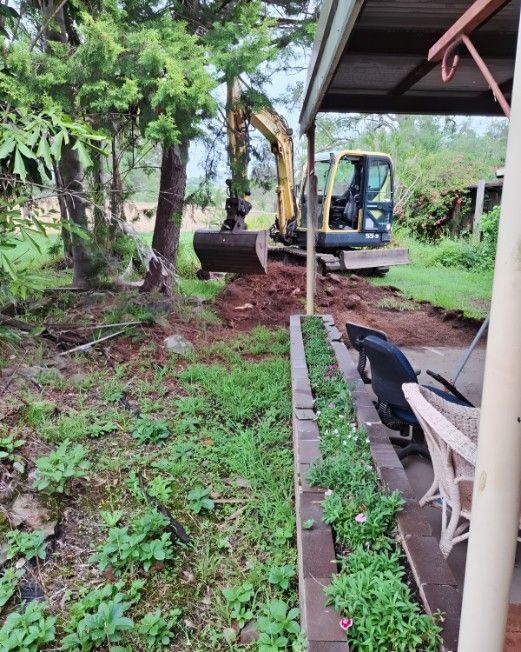 An Excavator is Digging a Hole in a Yard — Barrington Coast Contracting in Minimbah, NSW