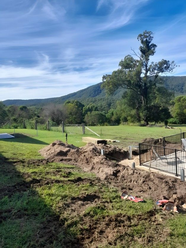 A Large Pile of Dirt is Sitting in the Middle of a Field — Barrington Coast Contracting in Bulahdelah, NSW