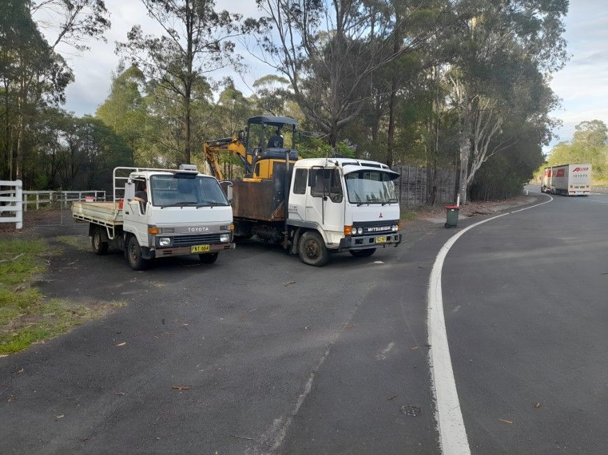 Two Trucks Are Parked Next to Each Other — Barrington Coast Contracting in Minimbah, NSW