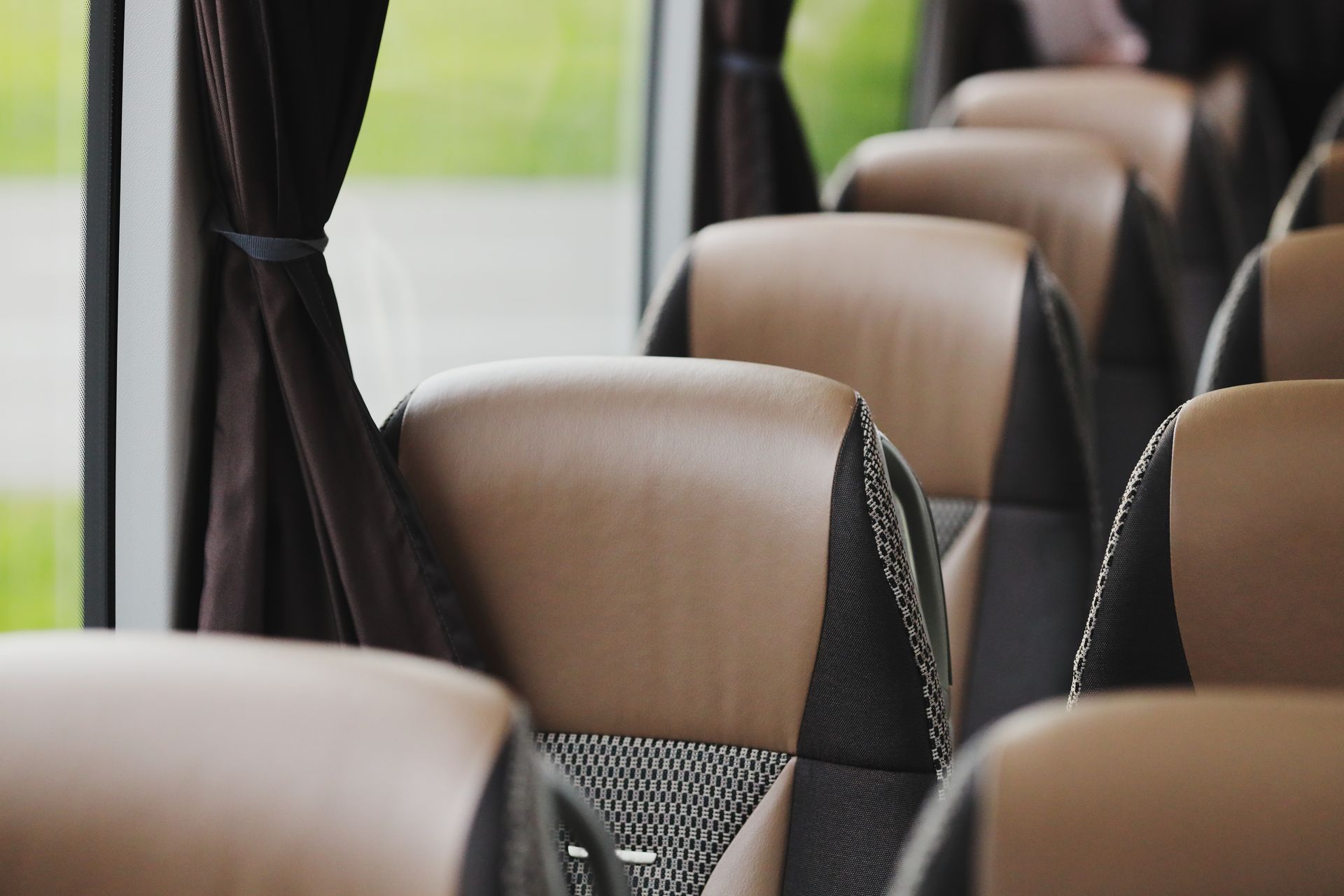 Empty bus interior with rows of brown and gray seats
