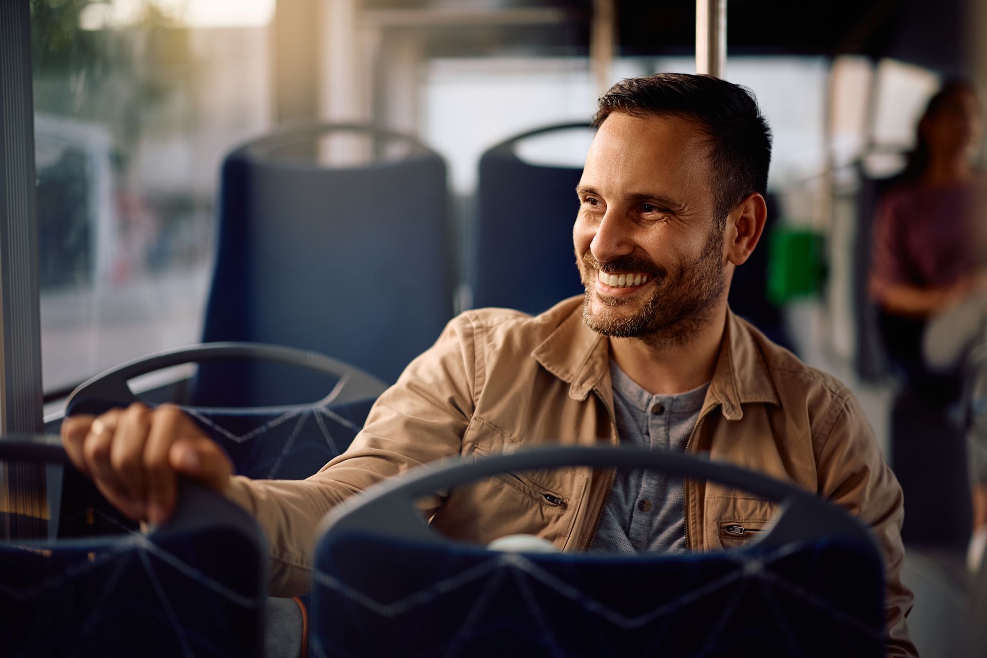 Man on a bus smiling