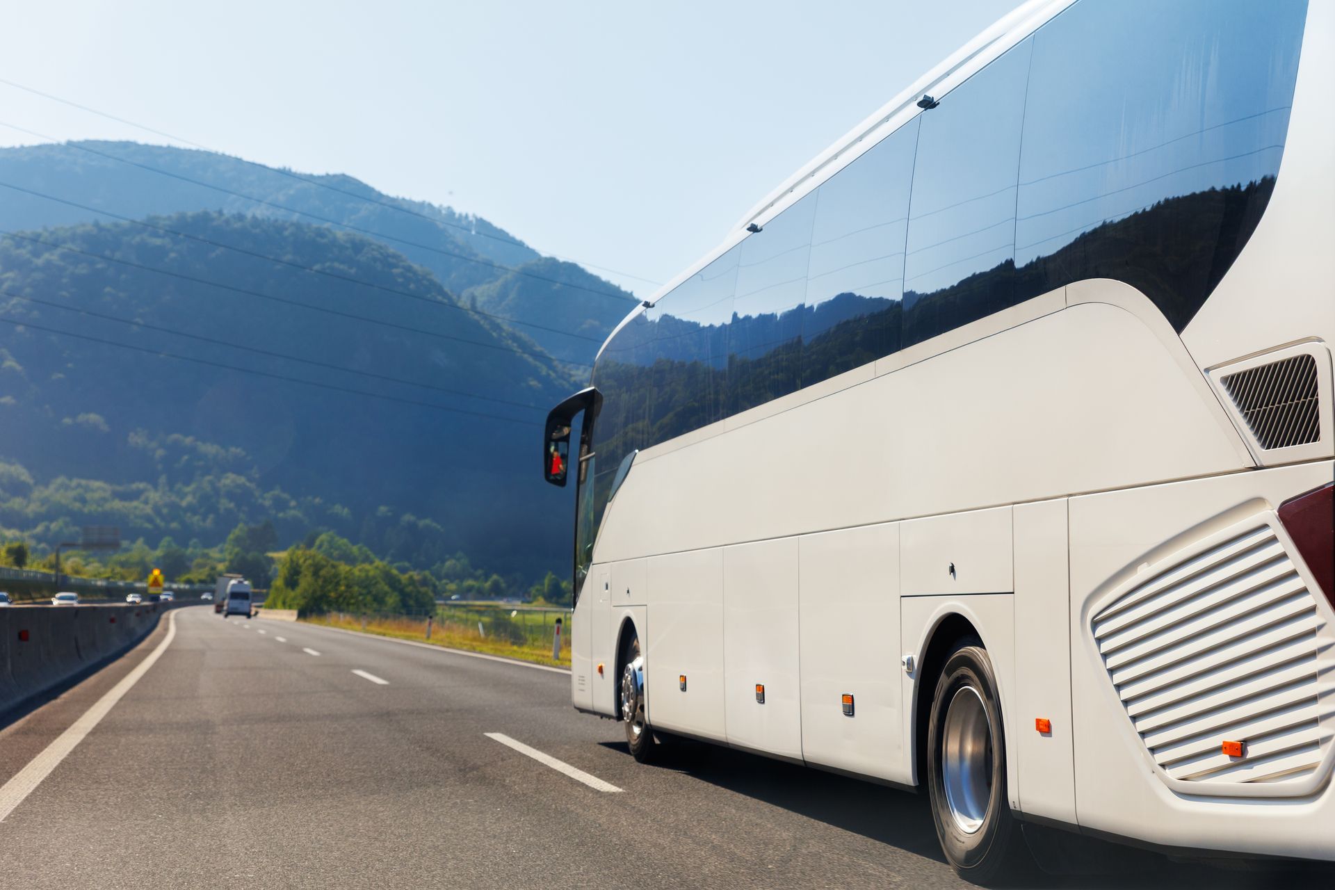 White tour bus on a highway
