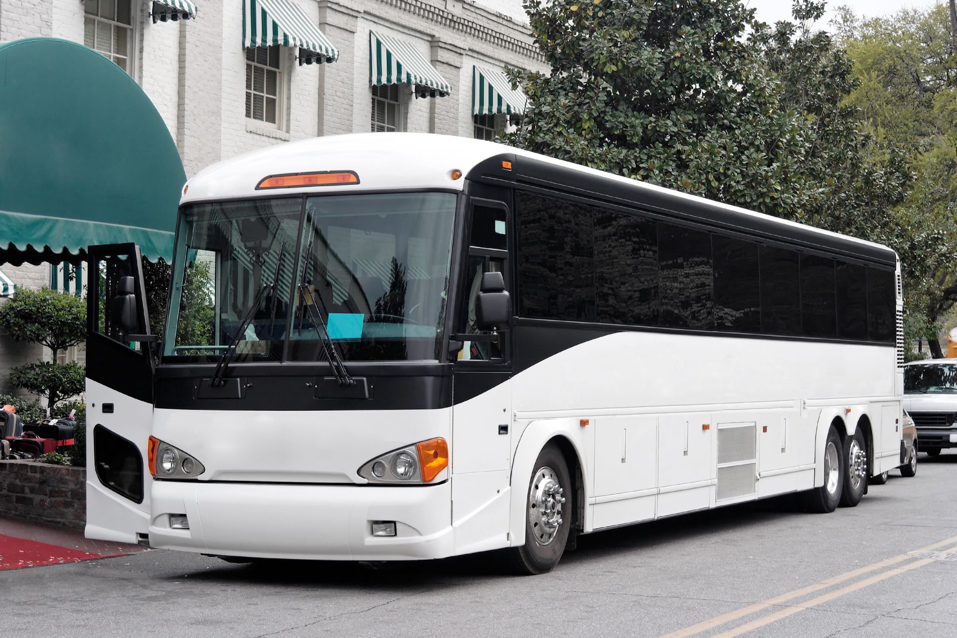 White tour bus parked on a city street
