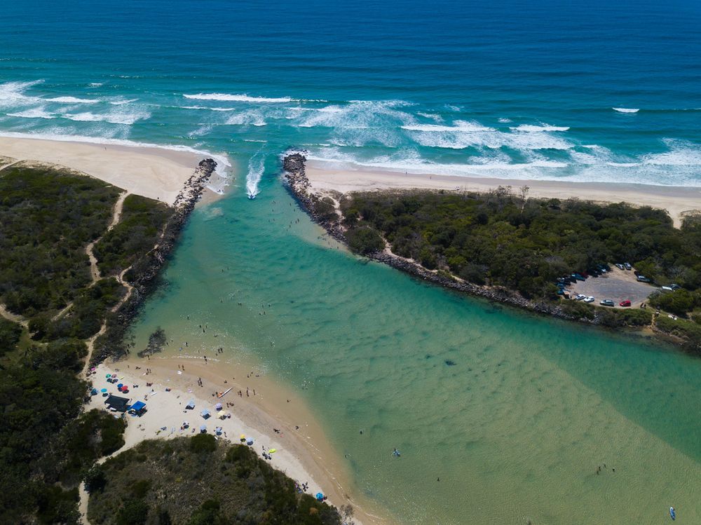 An Aerial View Of A River Flowing Into The Ocean Next To A Beach — Holloway Brothers In Pottsville, NSW