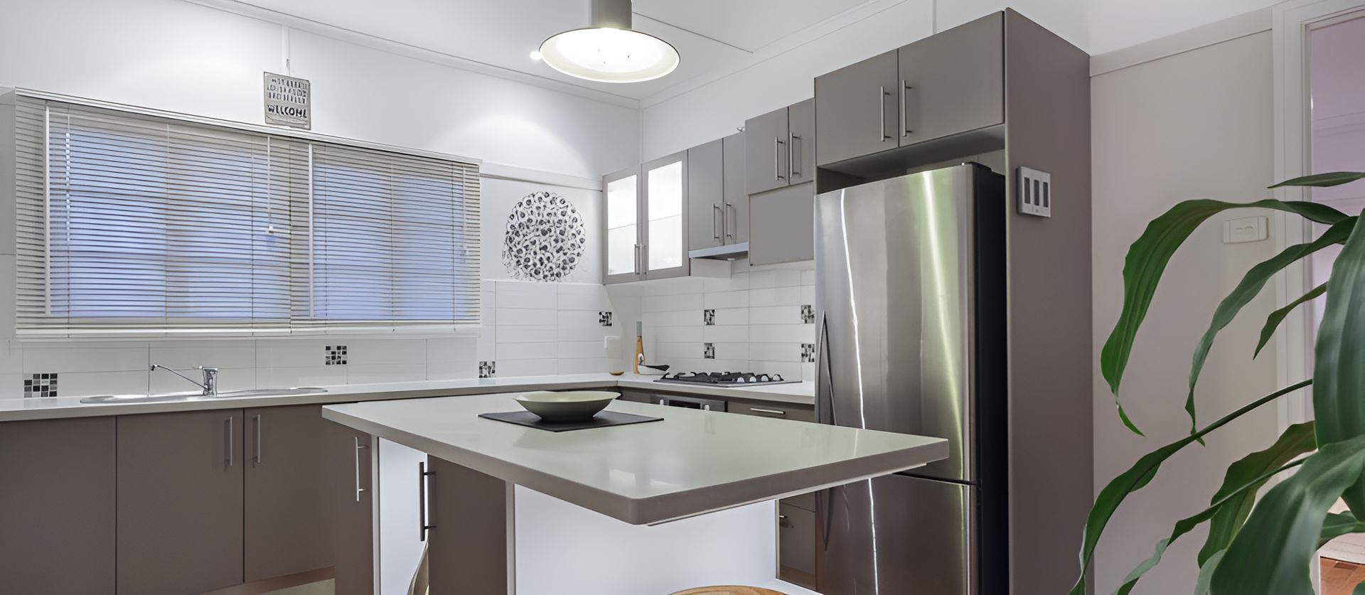 A Kitchen With Stainless Steel Appliances And A Stainless Steel Refrigerator — Holloway Brothers In Casuarina, NSW