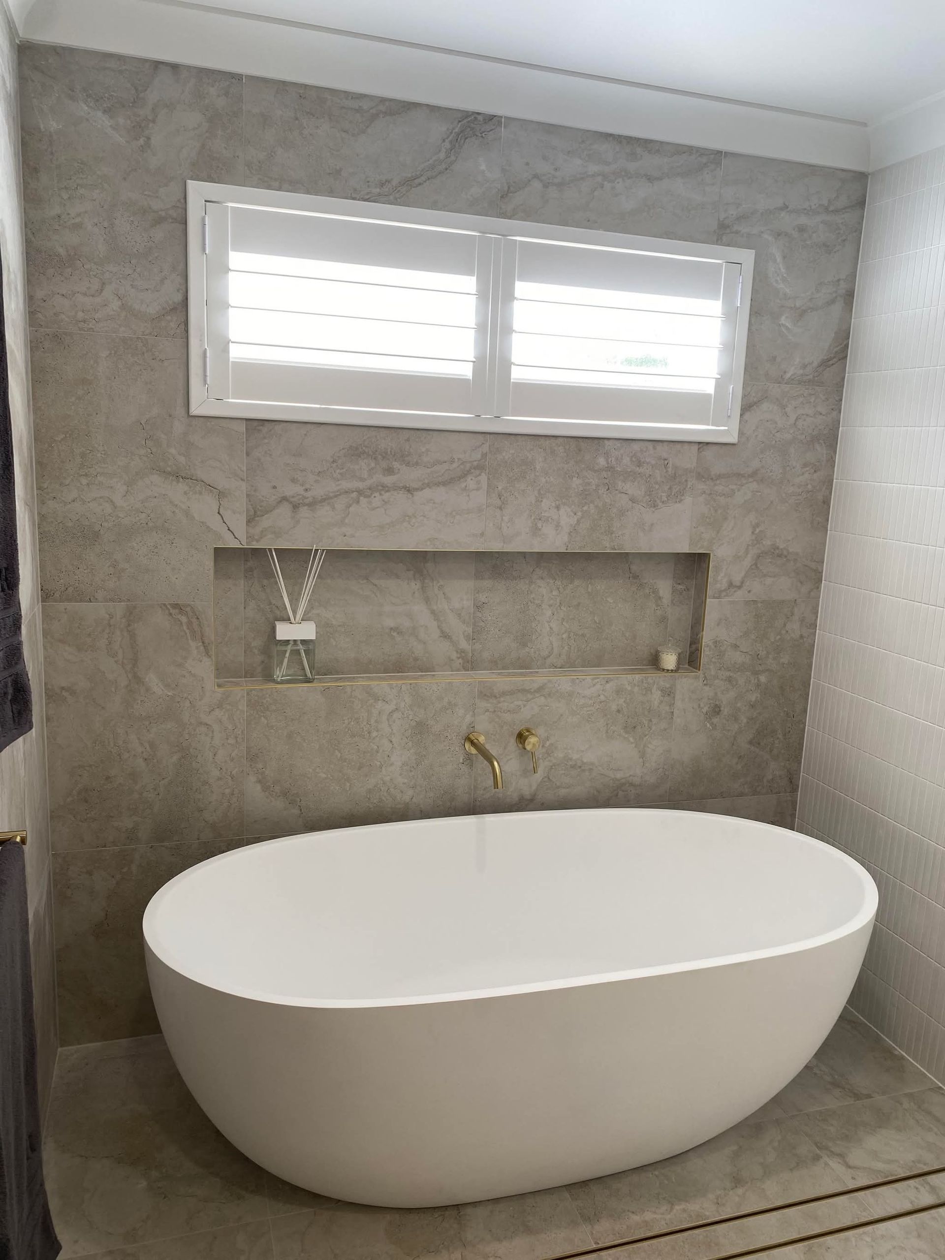 A renovated White Bathtub with Grey Tiles on the Wall — Holloway Brothers In Tweed Heads, NSW