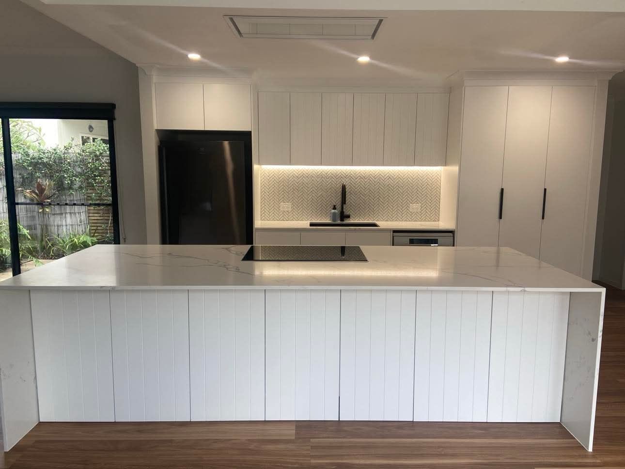 Large White Kitchen Bench and Kitchen Cabinets with White and Grey Tiles — Holloway Brothers In Tweed Heads, NSW